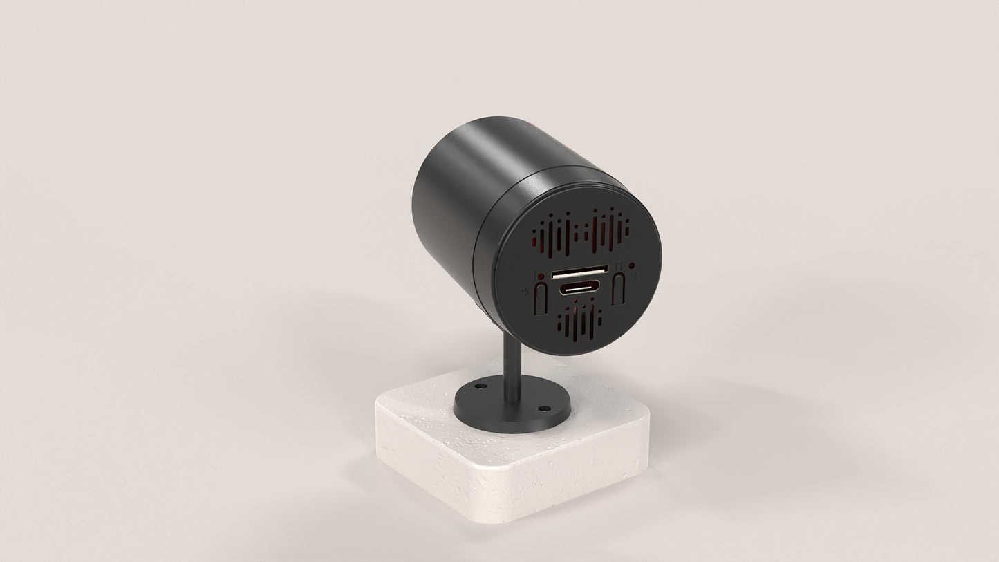 Black cylindrical device with ports on a white stand against a light gray background